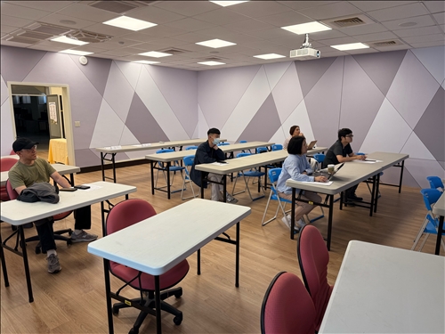 學生認真聆聽講解，筆記與操作電腦同步進行。