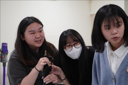 同學認真聆聽與看業師架燈